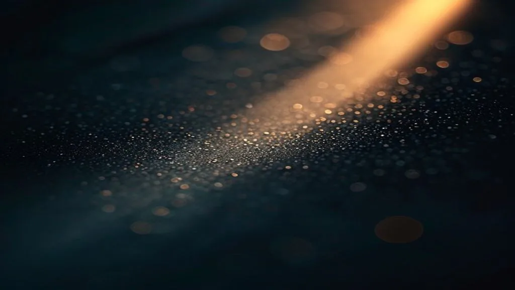 A single beam of focused light striking a polished metallic surface against a dark background